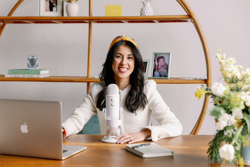 Desirée Adams sits at desk, recording a podcast episode about the things no one tells you about becoming a full-service planner.