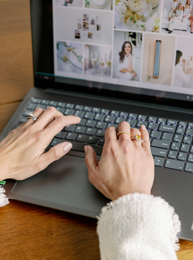 Desirée Adams types on Macbook as she updates a wedding inquiry workflow in her planning business.